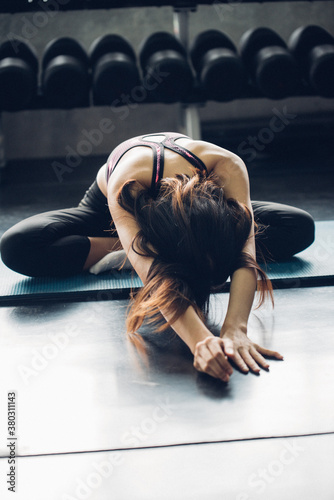 Young Woman Practicing Yoga In Gym