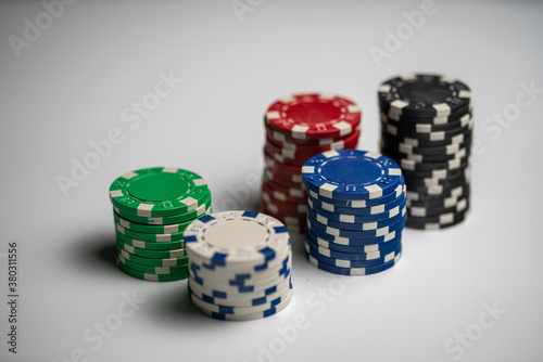 five stacked poker chips in different colors