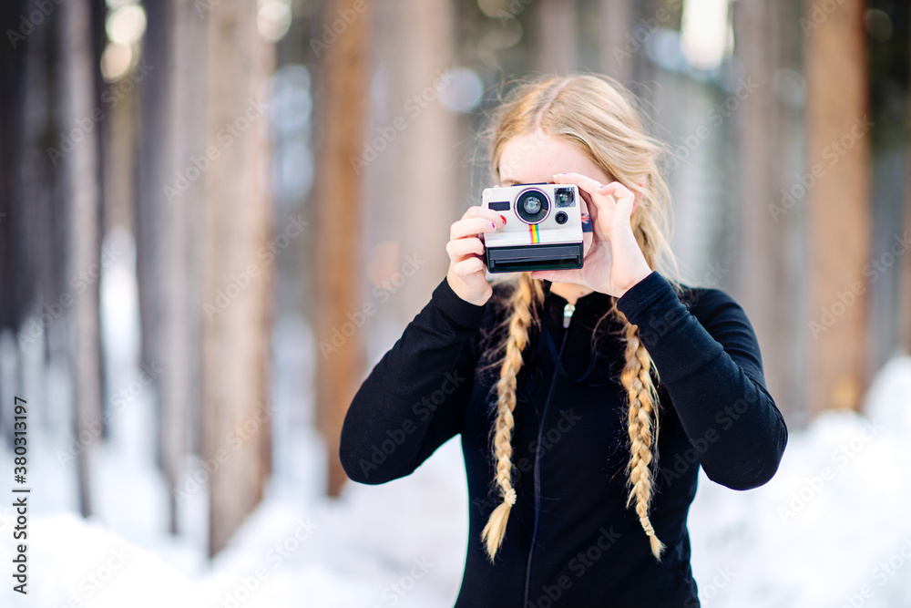Teenage Girl Taking A Photo With A Polaroid Camera In Winter Stock Teenage Girl Taking A Photo With A Polaroid Camera In Winter Stock