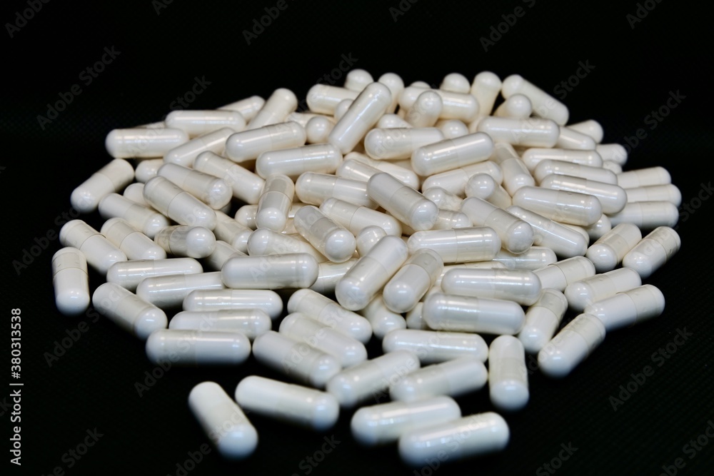 white pills isolated on black white pills isolated on black