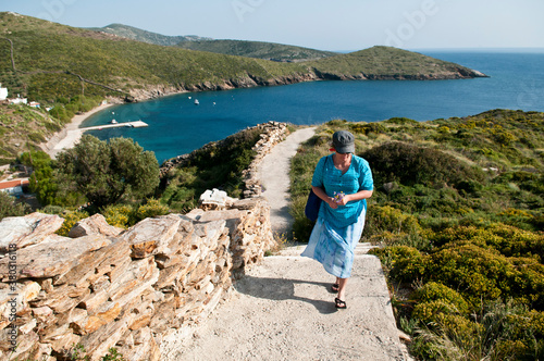 Woman walking up steps from a beach on Fourni Island, Greece. photo