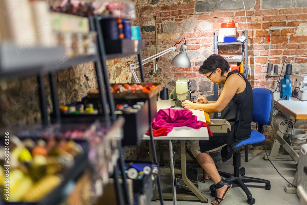 Tailor is Working with a Sewing Machine Tailor is Working with a Sewing Machine
