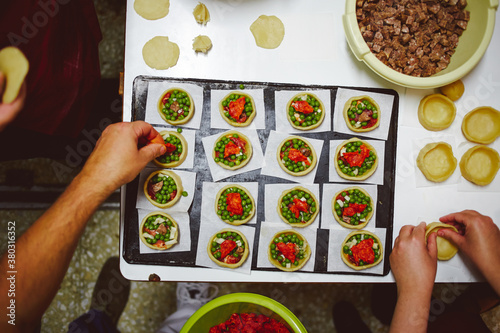Preparing peas and meat torts