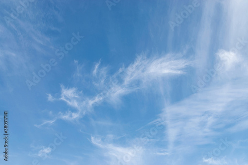 White cirrus clouds on a blue sky  background and pattern