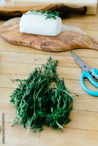 Cutting herbs to garnish goat's cheese photo