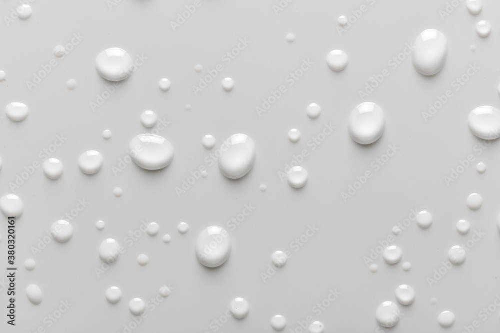 Full background of water droplets, moisture or condensation on a white background. Liquid drops on bathroom tile or smooth surface. Full background of water droplets, moisture or condensation on a white background. Liquid drops on bathroom tile or smooth surface.