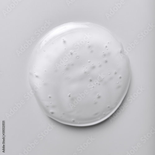 Single blob of transparent glycerin or gel. Glossy texture with tiny bubbles isolated on a white background.