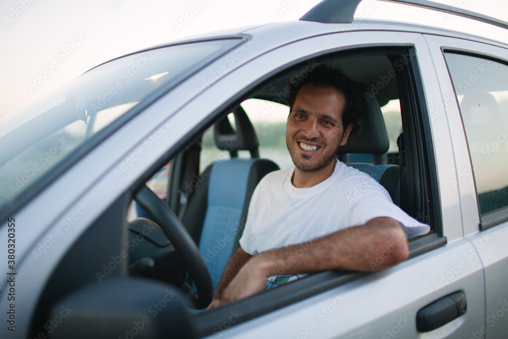Caucasian man in car at beach Caucasian man in car at beach