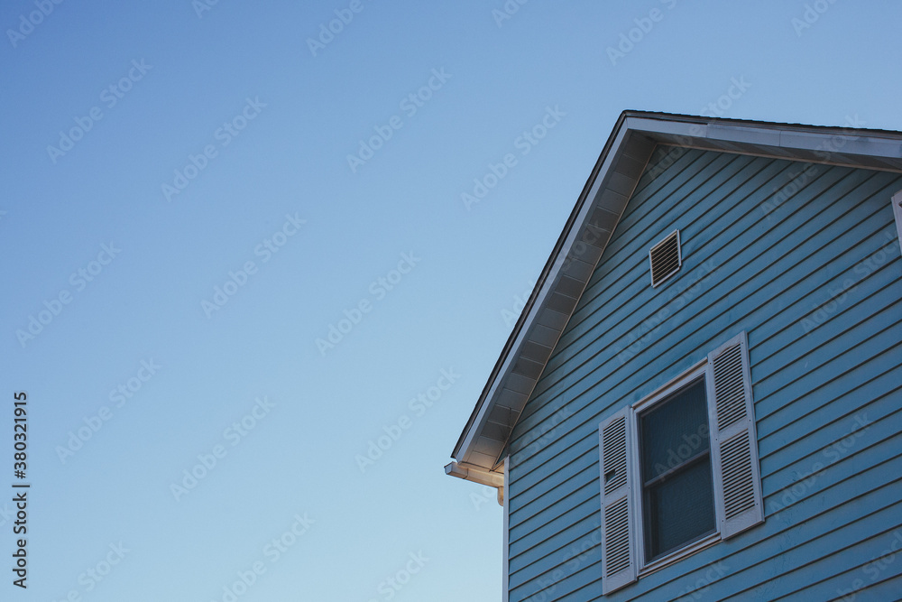 Side angle of the face of an old blue house Side angle of the face of an old blue house