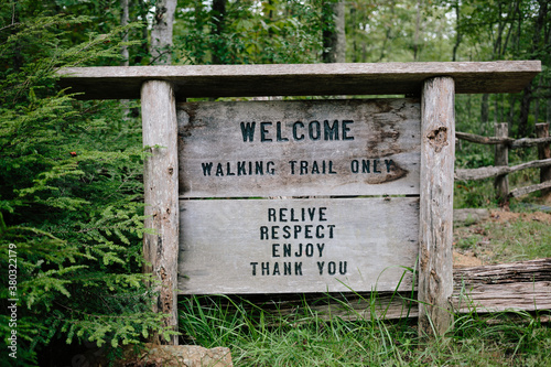 Welcome sign at a forest trail head