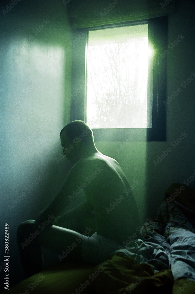Man Sitting on his Bed in the Morning Man Sitting on his Bed in the Morning
