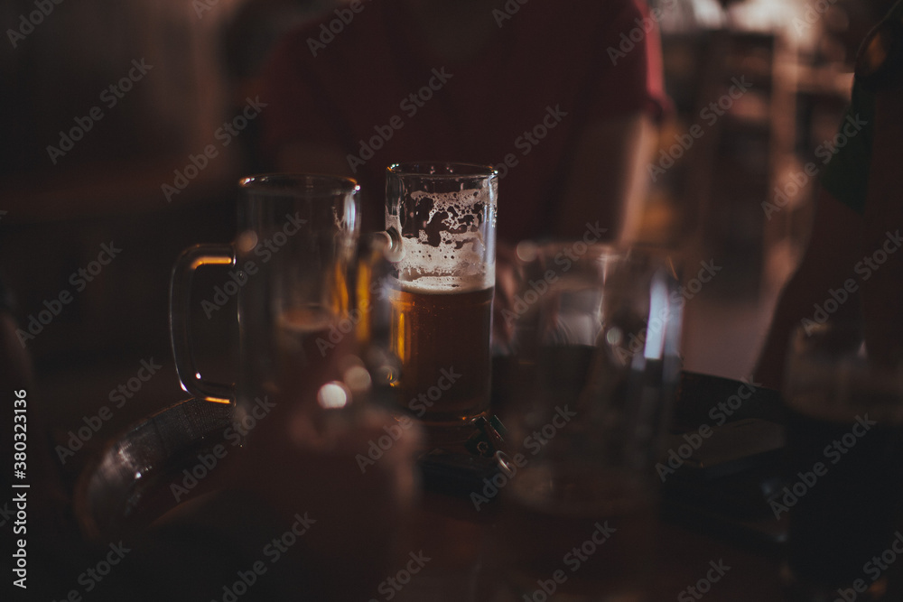 Table of beer glasses with one centered and well lit Table of beer glasses with one centered and well lit
