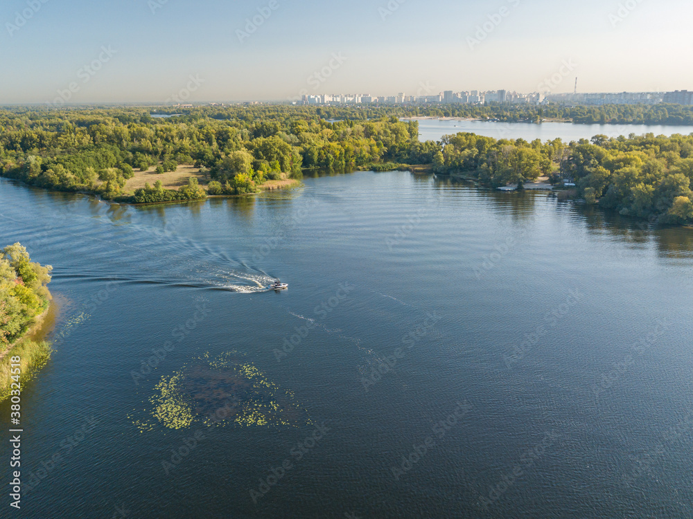 Aerial drone view. Motor boat on the Dnieper river in Kiev. Sunny day.