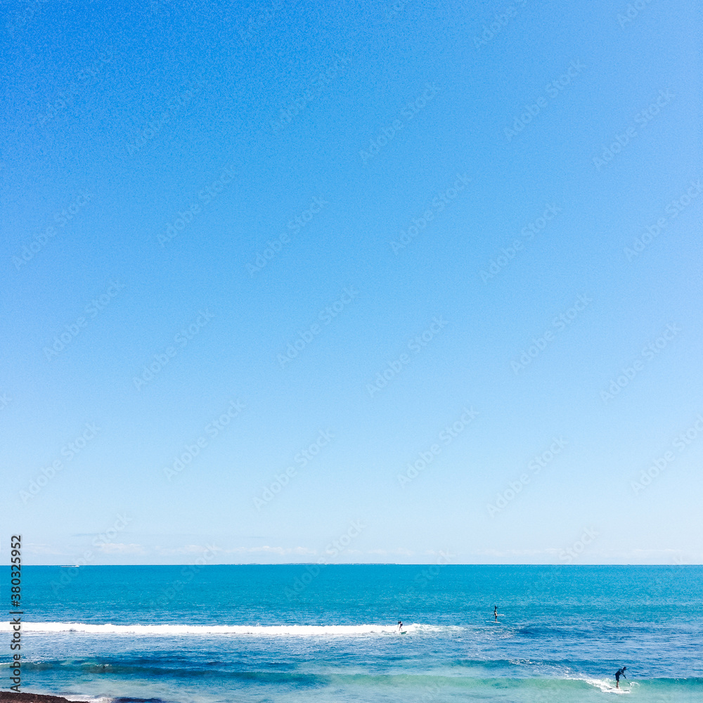 Small group of stand up paddle boarders on the ocean Small group of stand up paddle boarders on the ocean