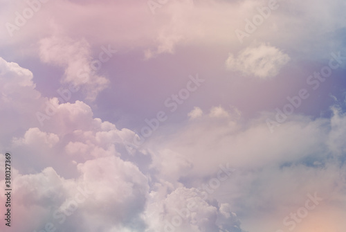 Colorful light in soft pastel tone of natural evening cloud and sky background before sunset. Heavy bulky cloud formation in rainy season. A tranquility atmosphere image for background and wallpaper.