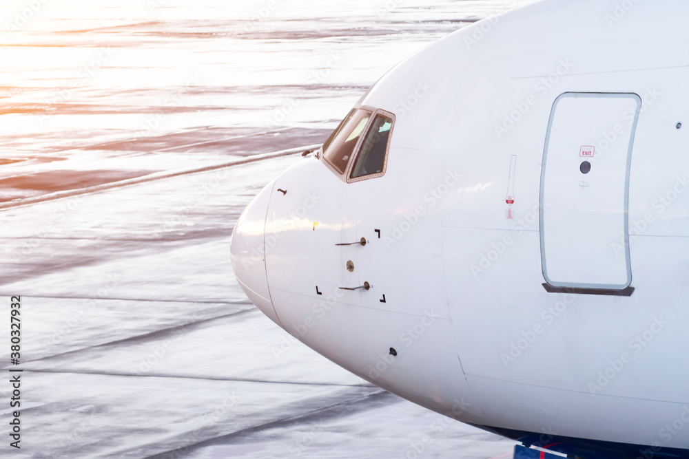 Widebody commercial jet airplane cockpit with door for entry-exit, side view.