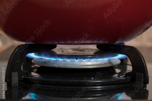 Wallpaper Mural a red pan on the cooker. macro or close up photo Torontodigital.ca