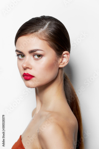 Beautiful woman stands sideways red lips attractive look 