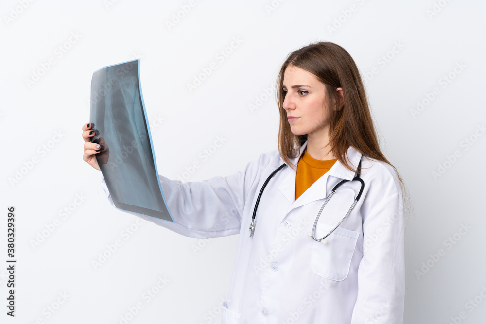 Young woman over isolated background wearing a doctor gown and holding a bone scan Young woman over isolated background wearing a doctor gown and holding a bone scan
