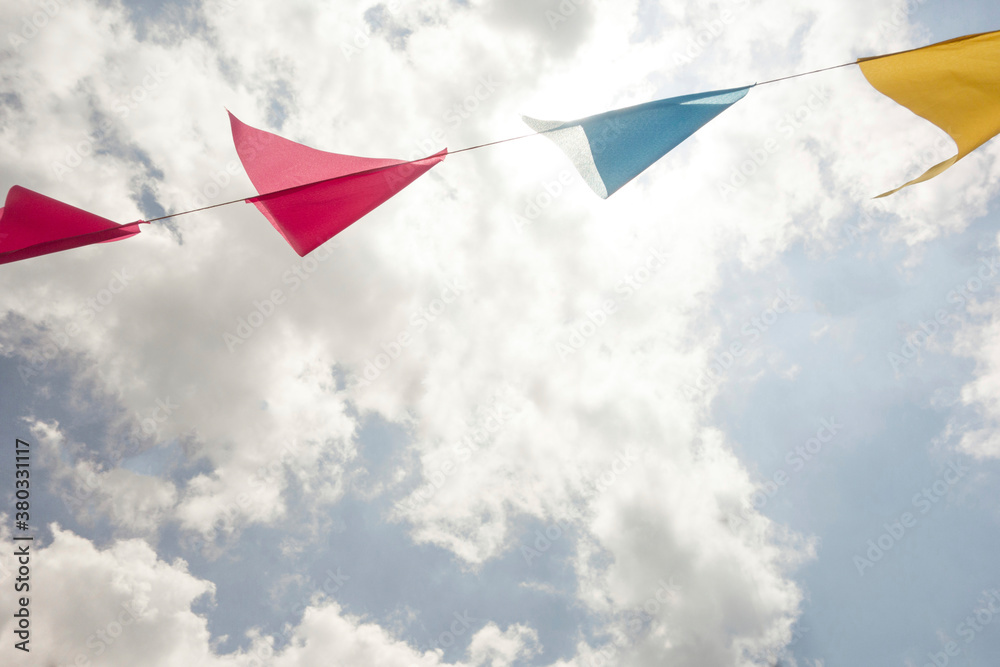 Festive colorful flags / banners against sky Festive colorful flags / banners against sky