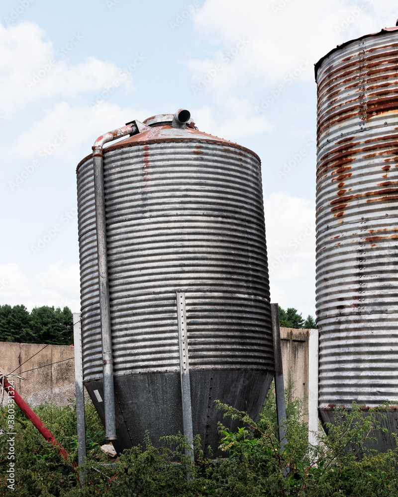 Leaning metal silo on farm