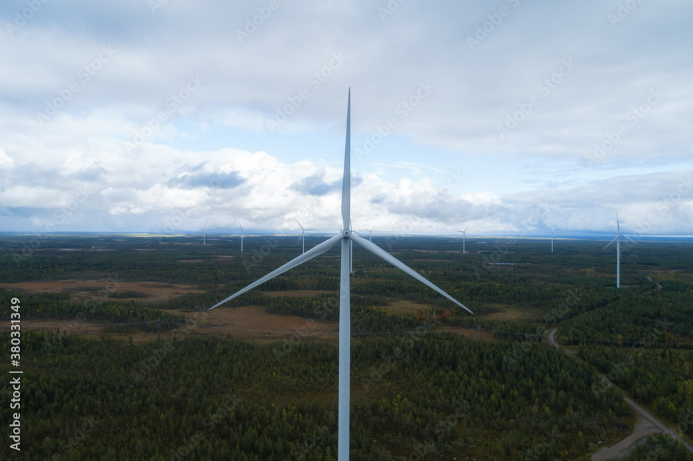 Aerial view of wind energy turbines on windfarm above. Clean energy. Finland.