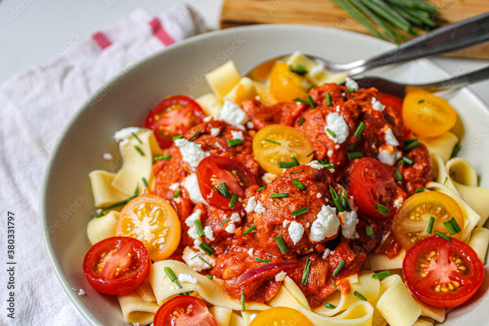 Meatball pasta with cherry tomatoes. Fresh beautiful pasta dish. White background. 