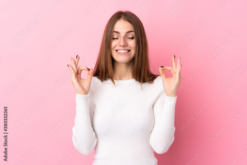 Young woman over isolated pink background in zen pose Young woman over isolated pink background in zen pose