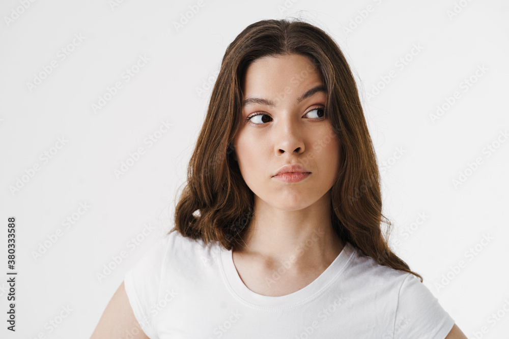 Pensive young woman thinking isolated over white Pensive young woman thinking isolated over white