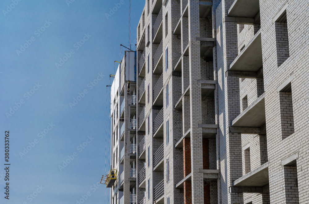 An unfinished skyscraper building against the blue sky. An unfinished skyscraper building against the blue sky.