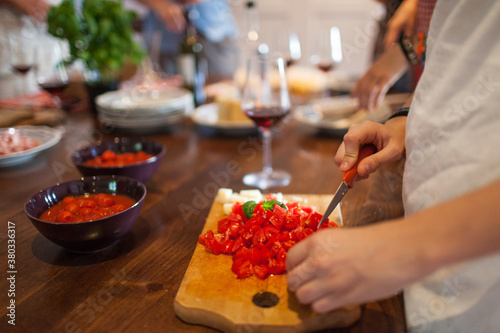 Group of Friends Preparing Tomato Sauce for Spaghetti Pasta photo