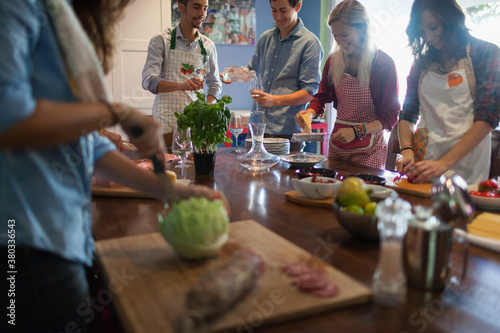 Group of Italian Friends Cooking Together Spaghetti Meal