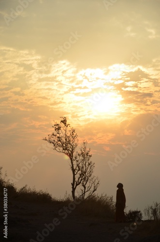 silhouette of lady with sunset