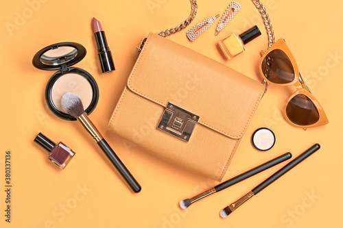 Beauty cosmetic makeup set. Fashion woman make up product, brushes, lipstick, nail polish orange monochrome collection. Creative concept. Cosmetology make-up accessories banner, top view.