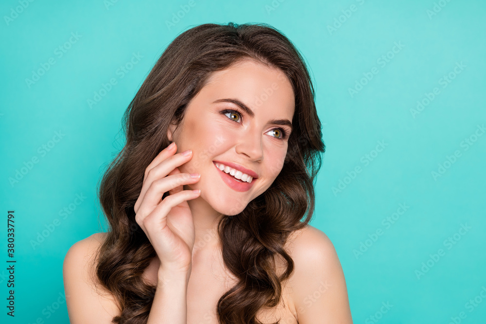Closeup photo of beautiful cheerful lady curly hairstyle smiling positive touch cheek perfect smooth skin spa salon procedure feel good look mirror nude isolated bright teal color background Closeup photo of beautiful cheerful lady curly hairstyle smiling positive touch cheek perfect smooth skin spa salon procedure feel good look mirror nude isolated bright teal color background