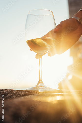 Woman's Hand Takes a Glass of White Wine