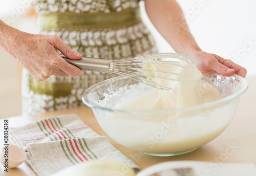 Midsection of woman whisking batter
