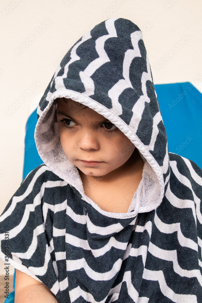 Child is angry and sad, wearing a bathrobe with a hood. Child is angry and sad, wearing a bathrobe with a hood.