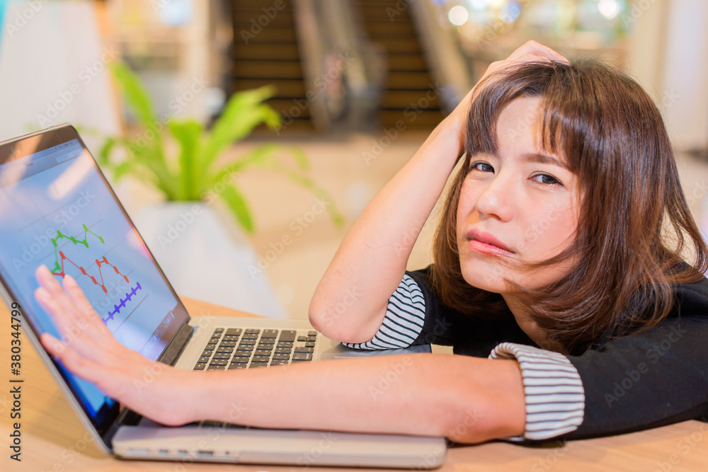 Stressed asian woman having headache while working using laptop computer at home. stressed and depressed. Work Failure Concept Stressed asian woman having headache while working using laptop computer at home. stressed and depressed. Work Failure Concept