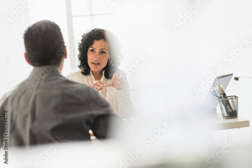 Business people talking at desk in office