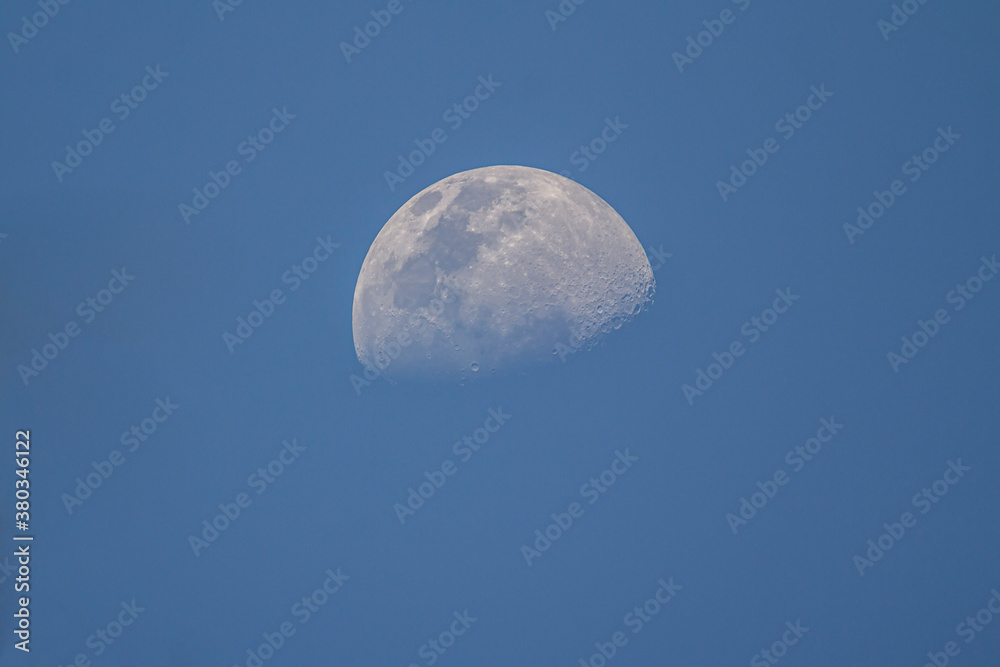 The moon is not full. See the details of the pit before the darkness. The surrounding sky is blue. The moon is not full. See the details of the pit before the darkness. The surrounding sky is blue.