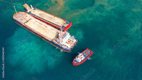 Aerial drone photo of construction ships and cranes building port of Piraeus expansion pier by pouring mud and sand to the sea, Attica, Greece © aerial-drone