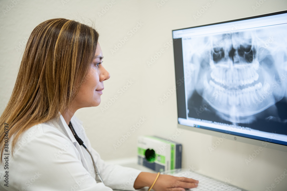 A dentist looking at x-rays A dentist looking at x-rays