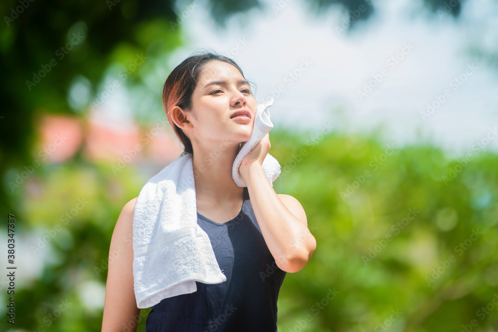 Attractive sport woman in runner sportswear breathing gasping and taking a break tired and exhausted after running in park. Copy space .. Attractive sport woman in runner sportswear breathing gasping and taking a break tired and exhausted after running in park. Copy space ..