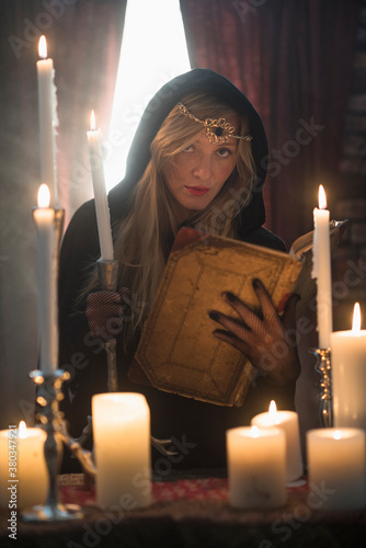 Portrait of sorceress in dark room photo