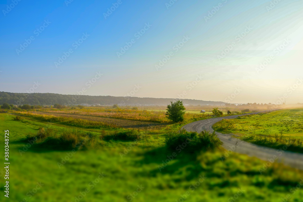 Morning sunrise over wide fields and meadows, countryside, Tilt-Shift effect,
