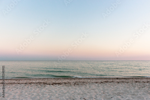 Evening seascape with dramatic sky. Summer nature. Scenic sunset sky over island beach. Tranquility concept. Scenic coastline background. Horizon over water. Bay landscape.