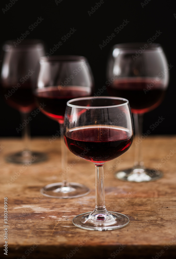 Red wine in glasses on wooden table, studio shot Red wine in glasses on wooden table, studio shot
