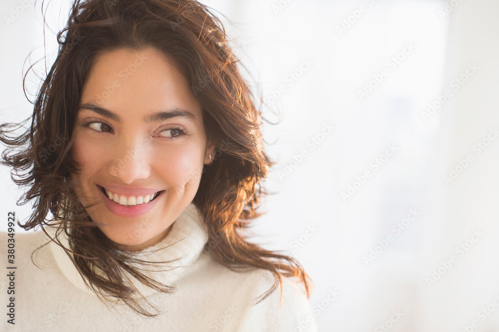 Smiling young woman looking sideways Smiling young woman looking sideways