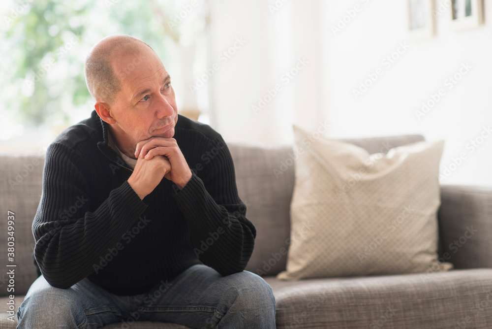 Portrait of mature man relaxing on sofa in living room Portrait of mature man relaxing on sofa in living room